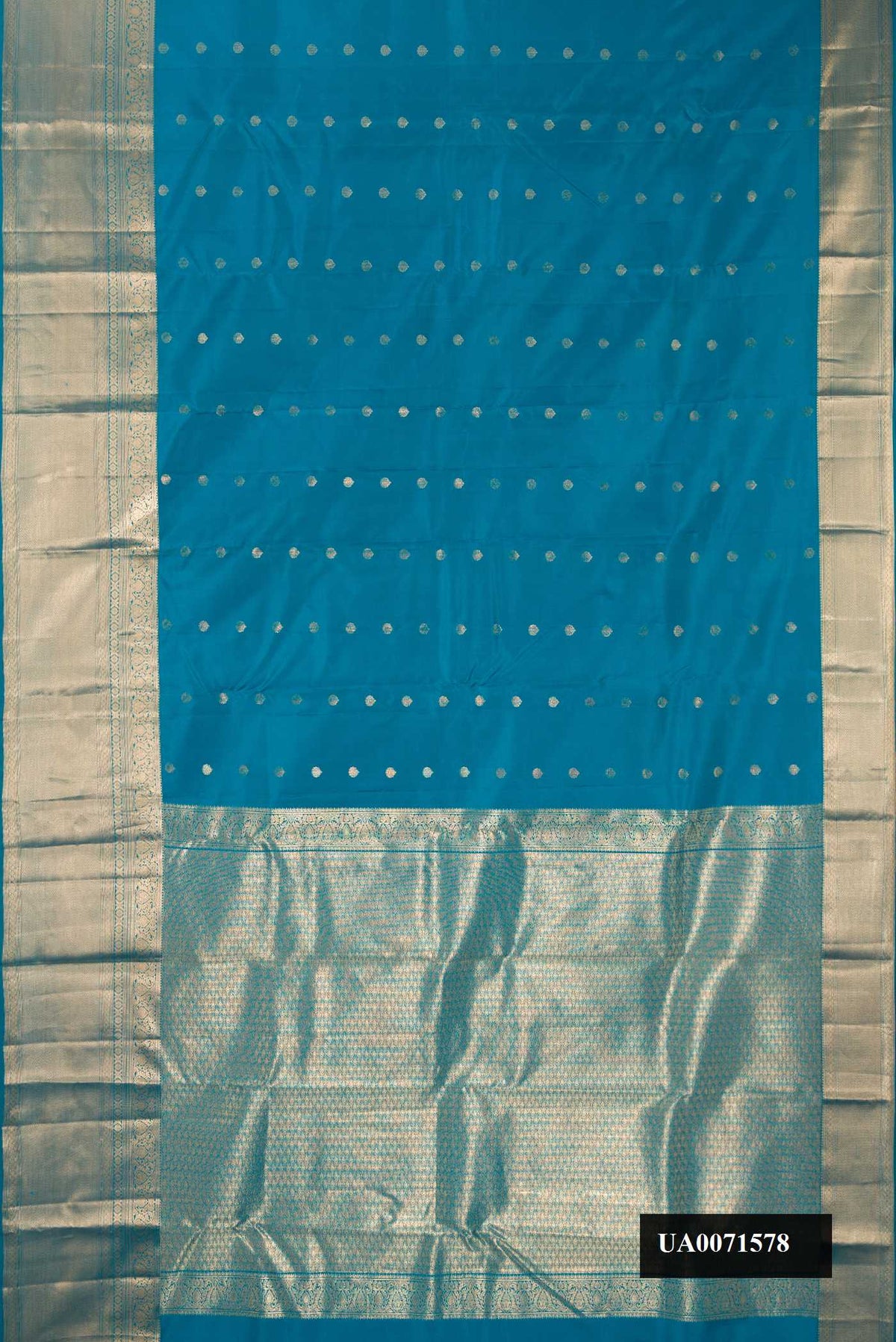 Peacock Blue Dual Tone Kanchipuram Silk Saree with Zari Butta on the body and Zari Border.  displayed on a mannequin