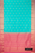 Sky Blue Dual Tone Kanchipuram Silk Saree with Zari Butta on the body and Zari Border.  displayed on a mannequin