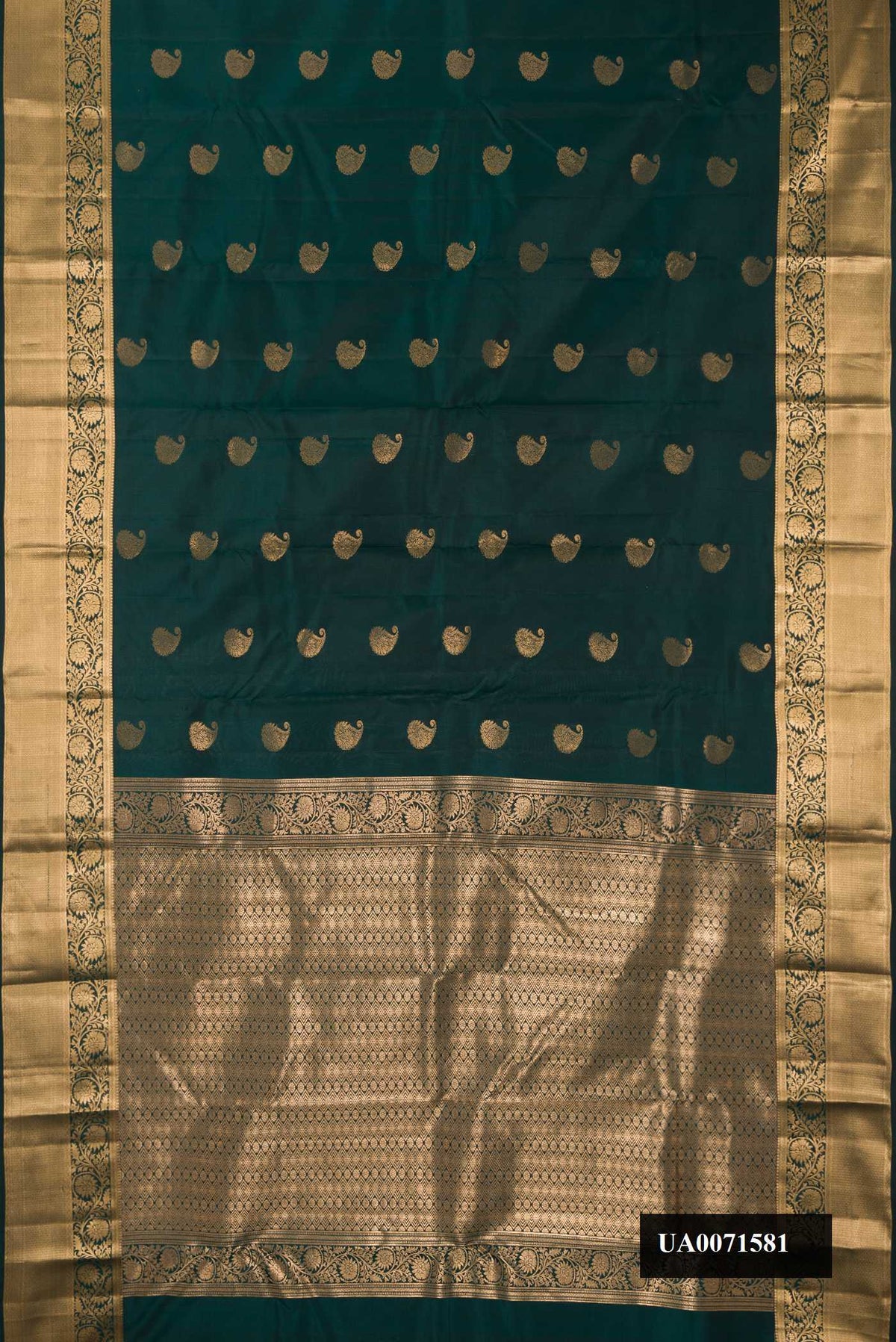 Bottle Green Dual Tone Kanchipuram Silk Saree with Zari Butta on the body and Zari Border.  displayed on a mannequin