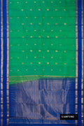 Green Dual Tone Kanchipuram Silk Saree with Zari Butta on the body and Zari Border.  displayed on a mannequin