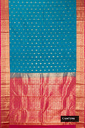 Sky Blue Dual Tone Kanchipuram Silk Saree with Zari Butta on the body and Zari Border.  displayed on a mannequin