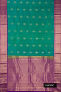 Sea Green Dual Tone Kanchipuram Silk Saree with Zari Butta on the body and Zari Border.  displayed on a mannequin