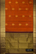 Rust Dual Tone Kanchipuram Silk Saree with Zari Butta on the body and Zari Border.  displayed on a mannequin