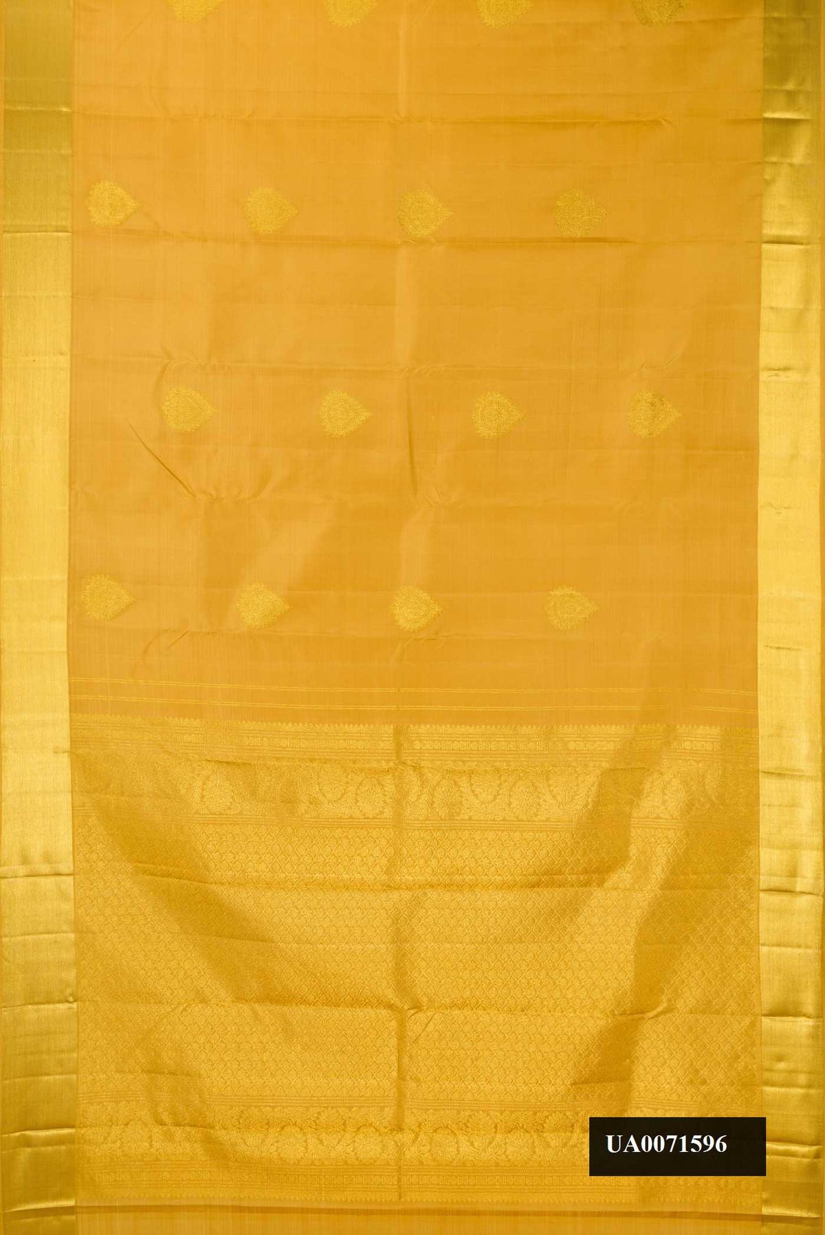 Gold Dual Tone Kanchipuram Silk Saree with Zari Butta on the body and Zari Border.  displayed on a mannequin