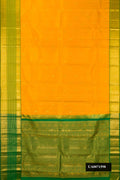 Mustard Dual Tone Kanchipuram Silk Saree with Zari Butta on the body and Zari Border.  displayed on a mannequin