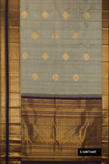 Grey Dual Tone Kanchipuram Silk Saree with Zari Butta on the body and Zari Border.  displayed on a mannequin