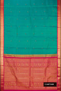 Peacock Blue Dual Tone Kanchipuram Silk Saree with Zari And Thread Butta on the body and Zari Border.  displayed on a mannequin