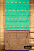 Sea Green Dual Tone Kanchipuram Silk Saree with Zari Butta on the body and Zari Border.  displayed on a mannequin