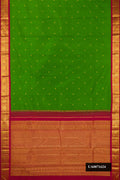 Green Dual Tone Kanchipuram Silk Saree with Zari Butta on the body and Zari Border.  displayed on a mannequin