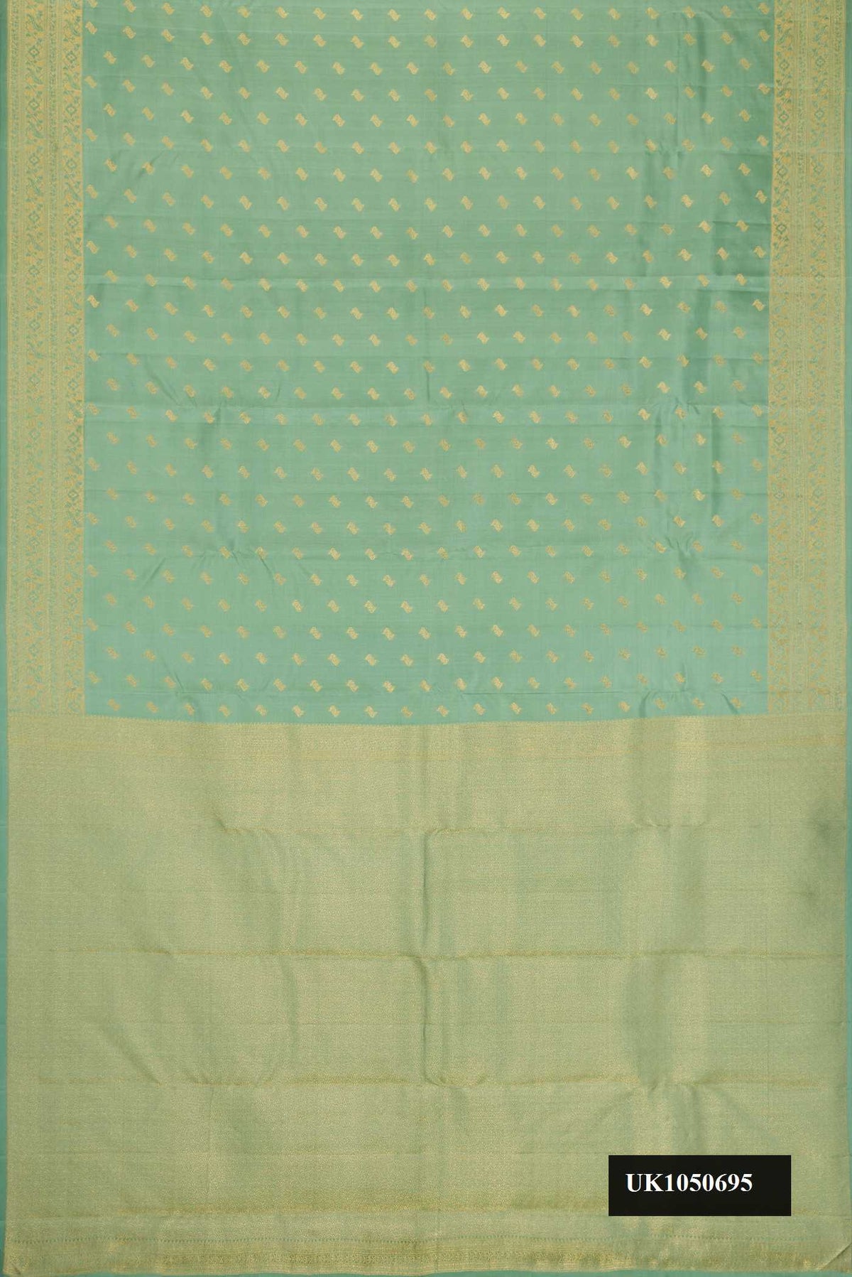 Pista Green Dual Tone Kanchipuram Silk Saree with Zari Butta on the body and Zari Border.  displayed on a mannequin