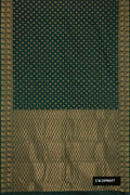 Bottle Green Dual Tone Kanchipuram Silk Saree with Zari Butta on the body and Zari Border.  displayed on a mannequin
