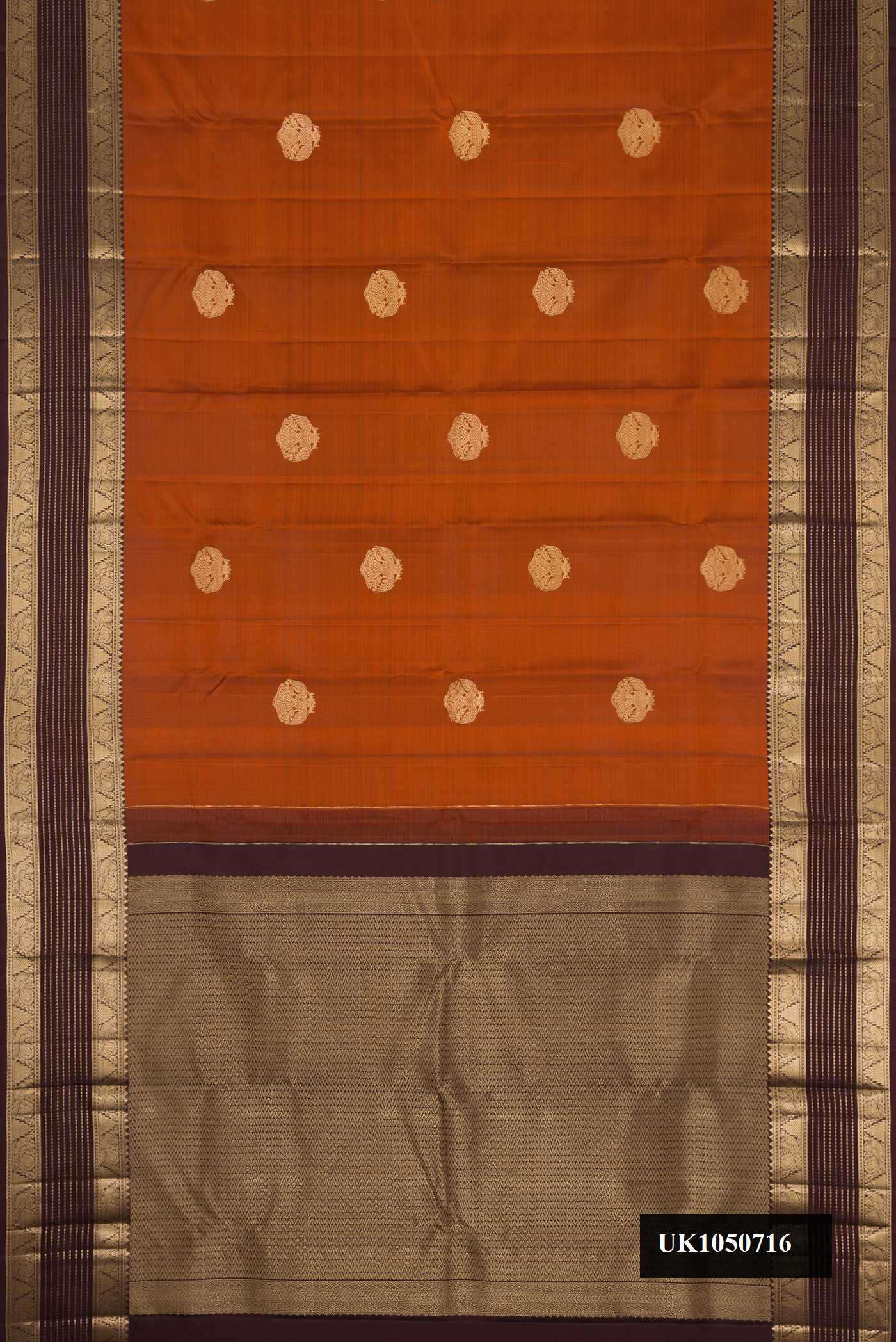 Brick Orange Dual Tone Kanchipuram Silk Saree with Zari Butta on the body and Zari Border.  displayed on a mannequin