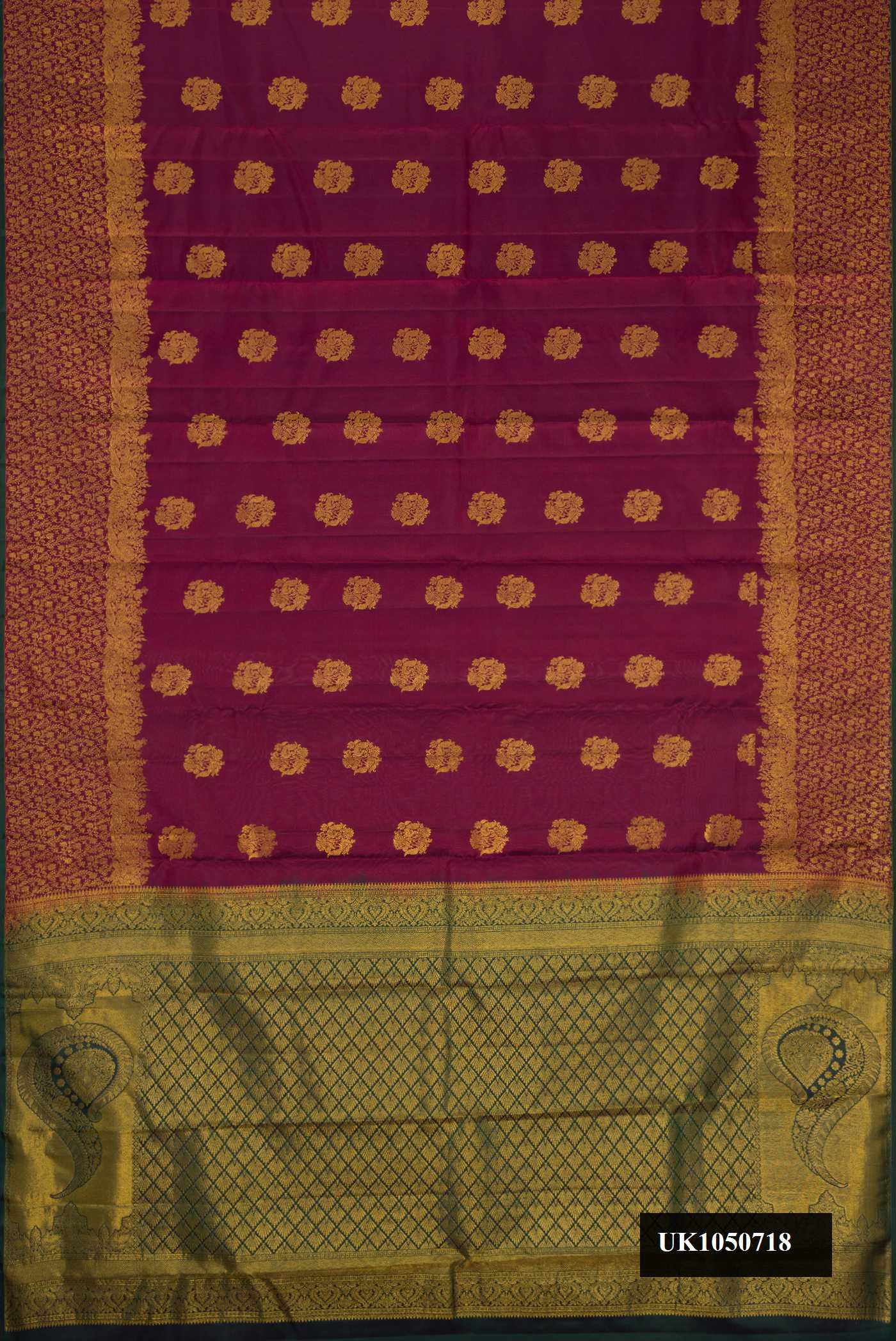 Maroon Dual Tone Kanchipuram Silk Saree with Zari Butta on the body and Zari Border.  displayed on a mannequin