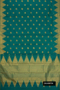 Green Dual Tone Kanchipuram Silk Saree with Zari Butta on the body and Zari Border.  displayed on a mannequin