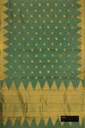 Green Dual Tone Kanchipuram Silk Saree with Zari Butta on the body and Temple Border.  displayed on a mannequin