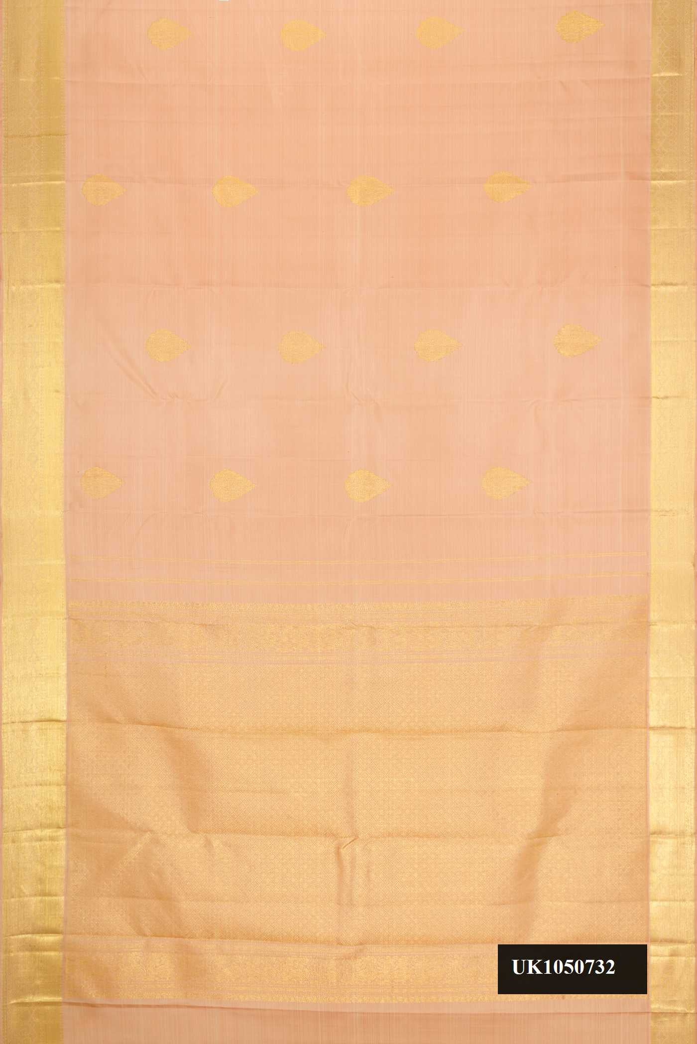 Golden Peach Dual Tone Kanchipuram Silk Saree with Zari Butta on the body and Zari Border.  displayed on a mannequin