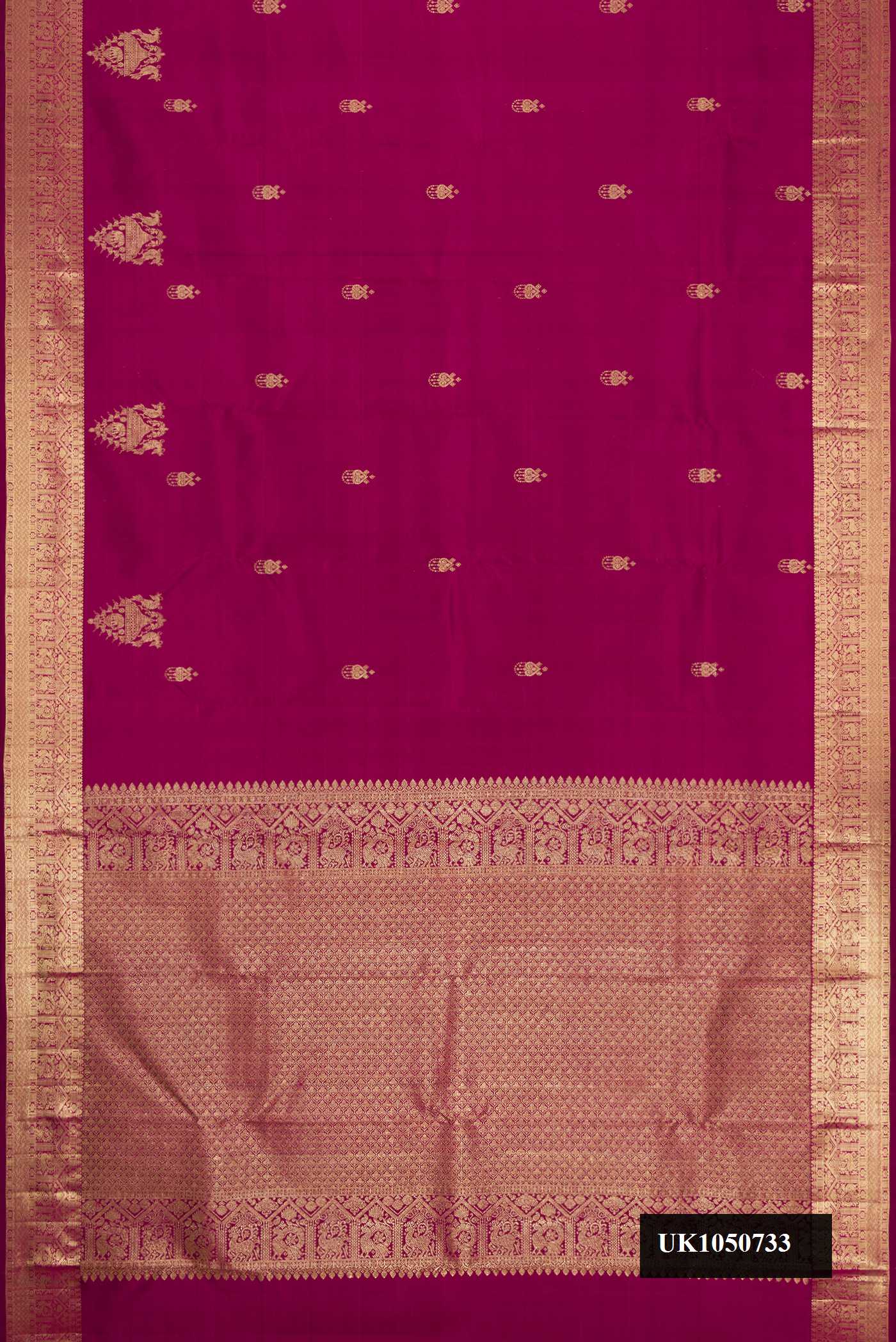 Magenta Dual Tone Kanchipuram Silk Saree with Zari Butta on the body and Zari Border.  displayed on a mannequin
