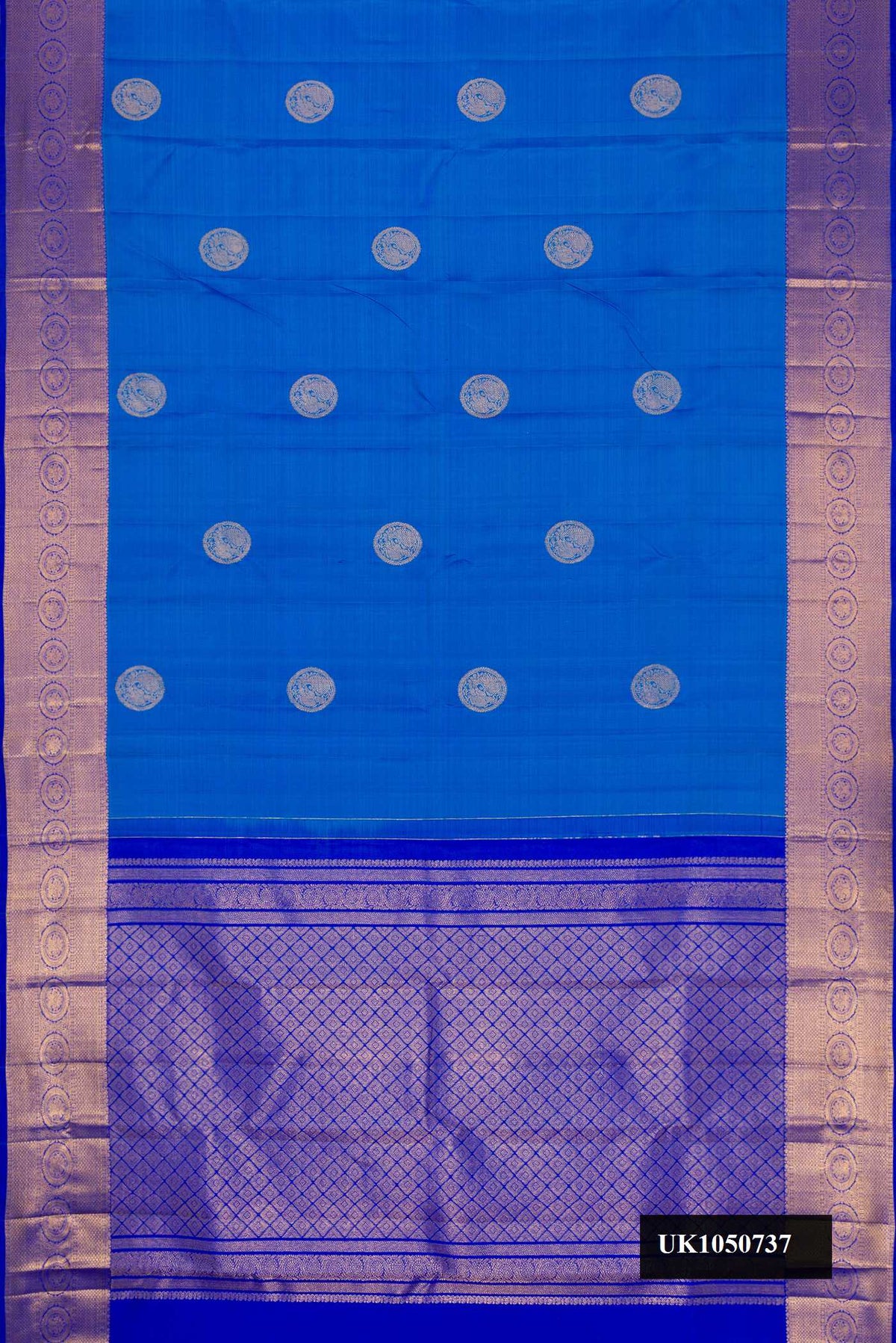 Sky Blue Dual Tone Kanchipuram Silk Saree with Zari Butta on the body and Zari Border.  displayed on a mannequin