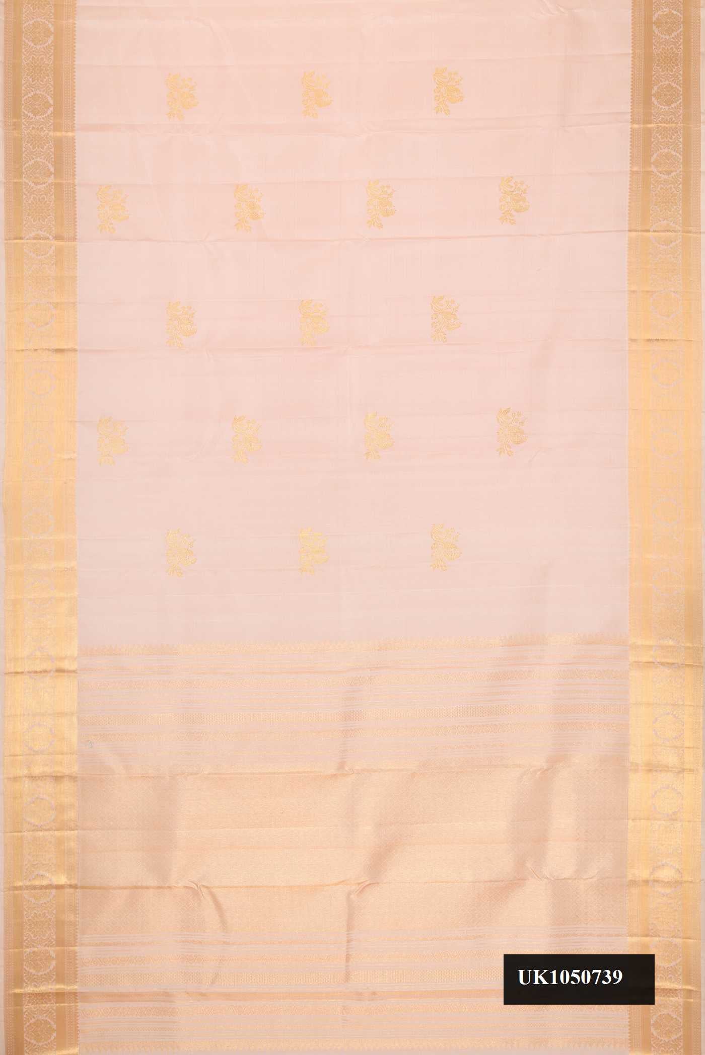 Rose Gold Dual Tone Kanchipuram Silk Saree with Zari Butta on the body and Zari Border.  displayed on a mannequin