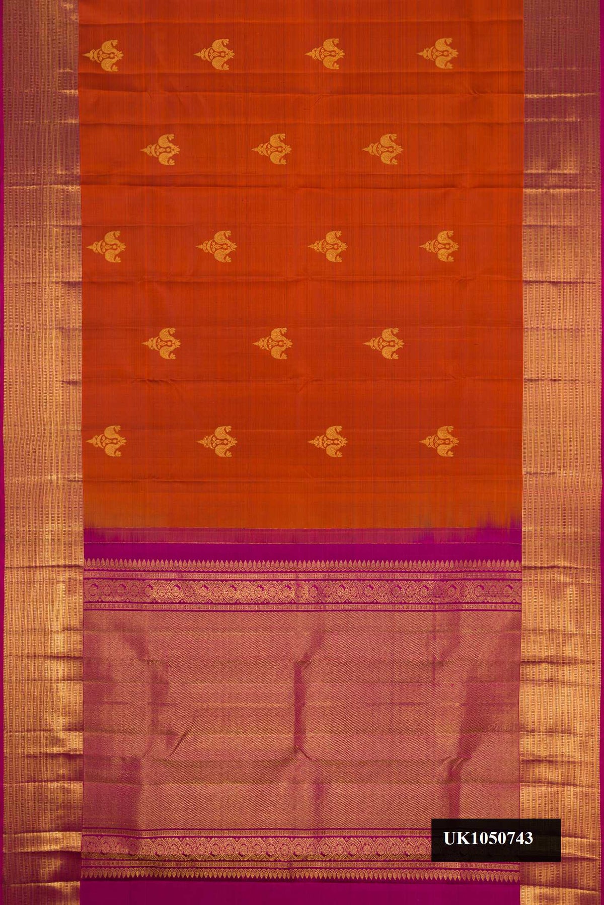 Orange Dual Tone Kanchipuram Silk Saree with Zari Butta on the body and Zari Border.  displayed on a mannequin