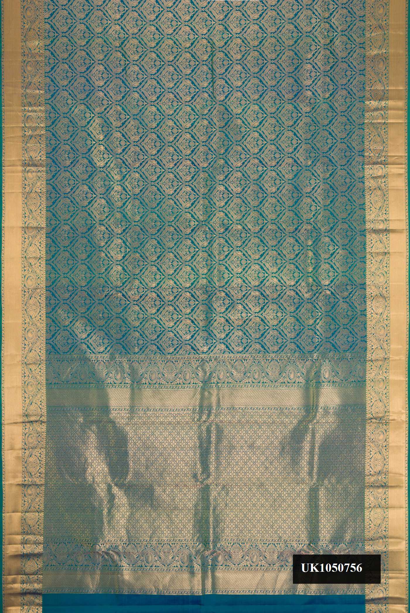 Peacock Blue Dual Tone Kanchipuram Silk Saree with Zari Brocade on the body and Zari Border.  displayed on a mannequin