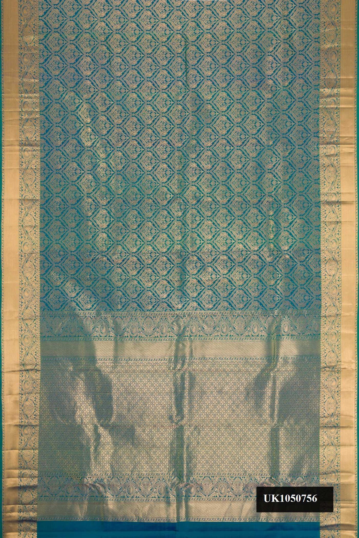 Peacock Blue Dual Tone Kanchipuram Silk Saree with Zari Brocade on the body and Zari Border.  displayed on a mannequin