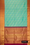 Sea Green Dual Tone Kanchipuram Silk Saree with Zari Brocade on the body and Zari Border.  displayed on a mannequin