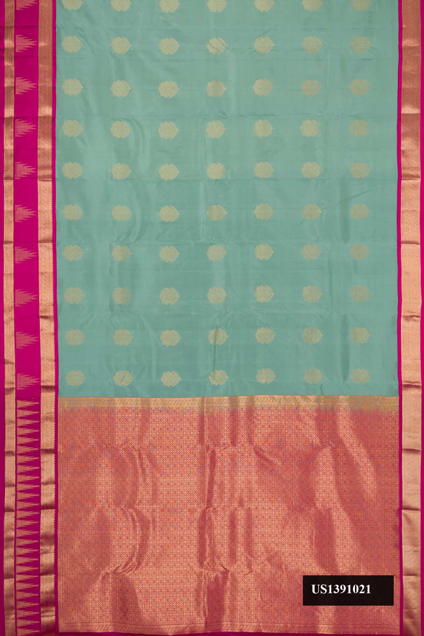 Green Dual Tone Kanchipuram Silk Saree with Zari Butta on the body and Zari Border.  displayed on a mannequin
