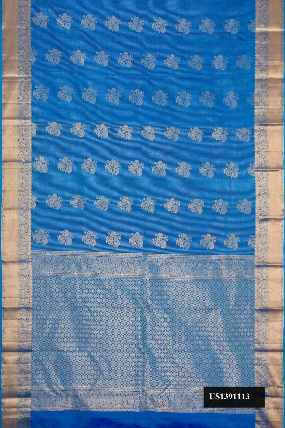 Light Blue Dual Tone Kanchipuram Silk Saree with Zari Butta on the body and Zari Border.  displayed on a mannequin