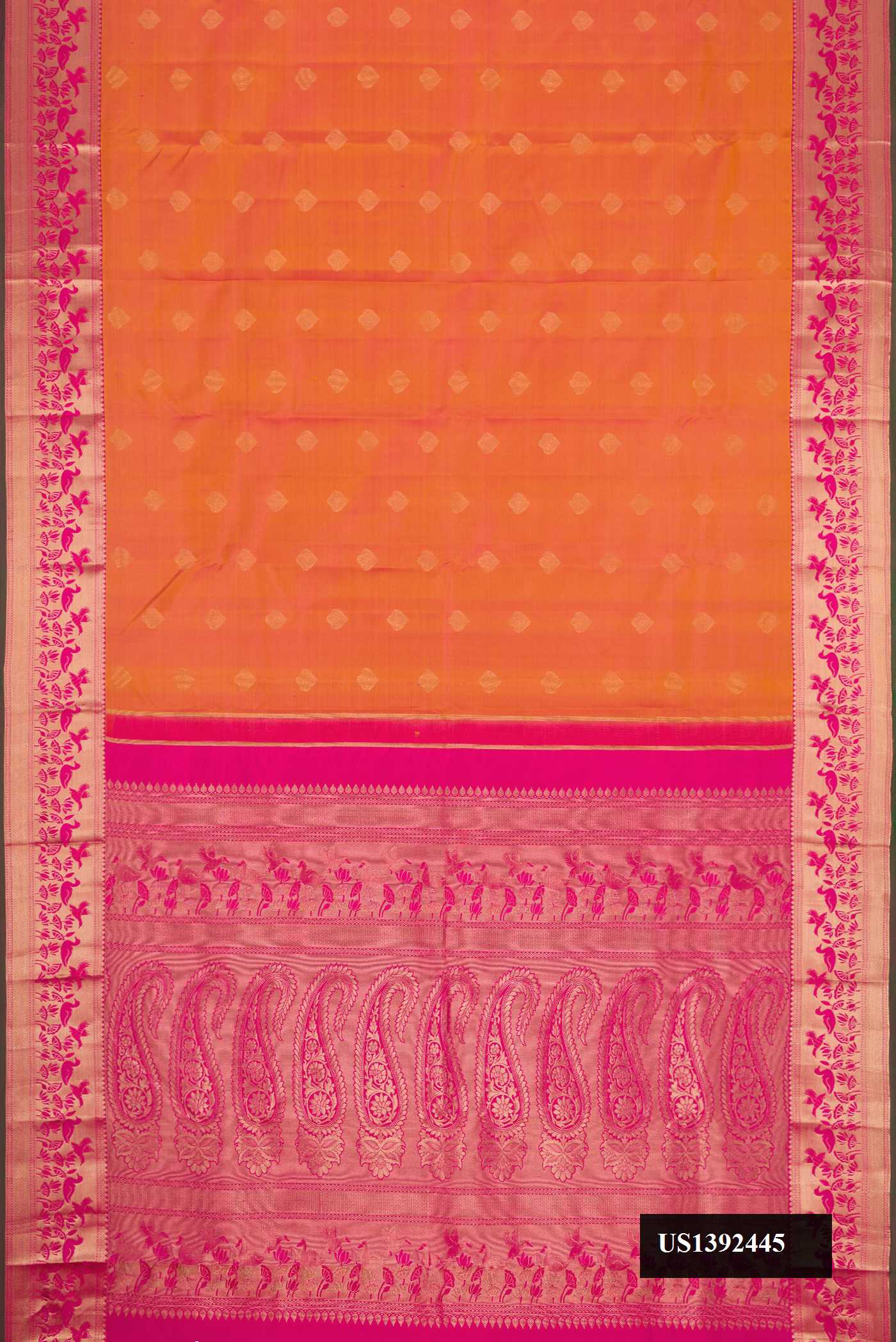 Brick Orange Dual Tone Kanchipuram Silk Saree with Zari Butta on the body and Zari Border.  displayed on a mannequin