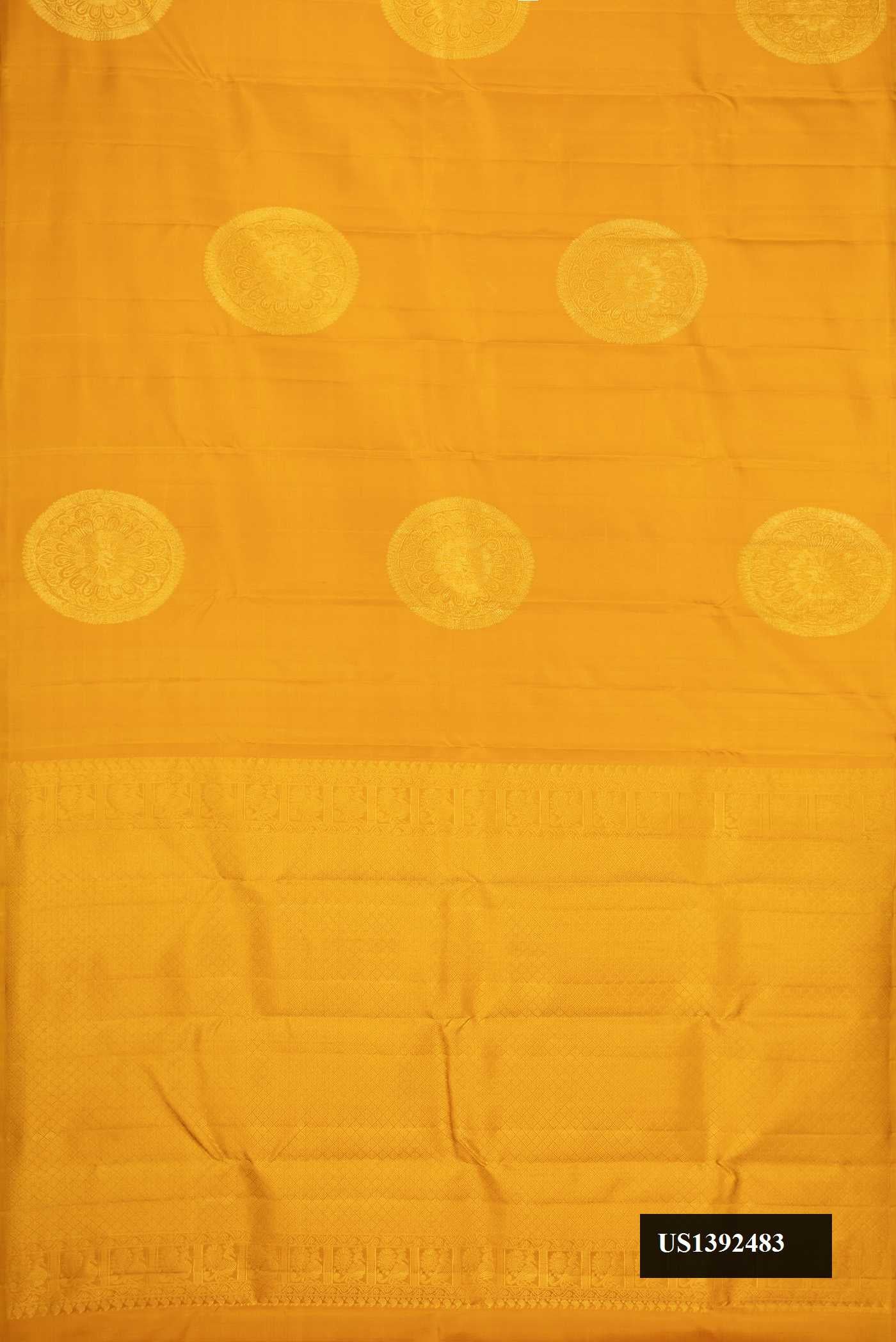 Mustard Dual Tone Kanchipuram Silk Saree with Zari Butta on the body and Without Border.  displayed on a mannequin