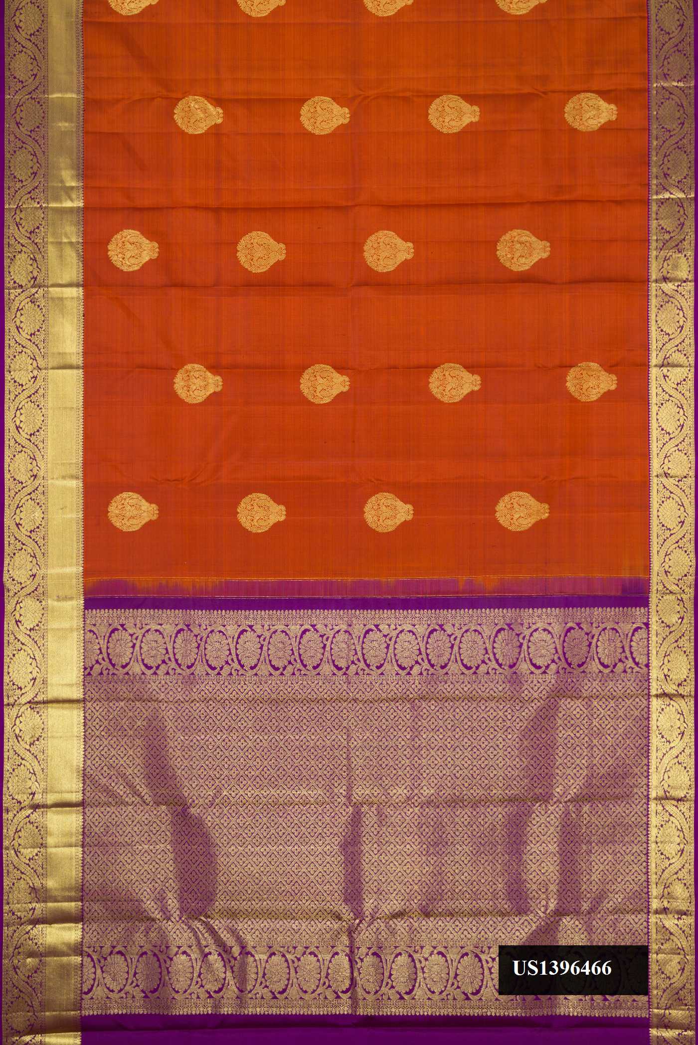 Brick Orange Dual Tone Kanchipuram Silk Saree with Zari Butta on the body and Zari Border.  displayed on a mannequin