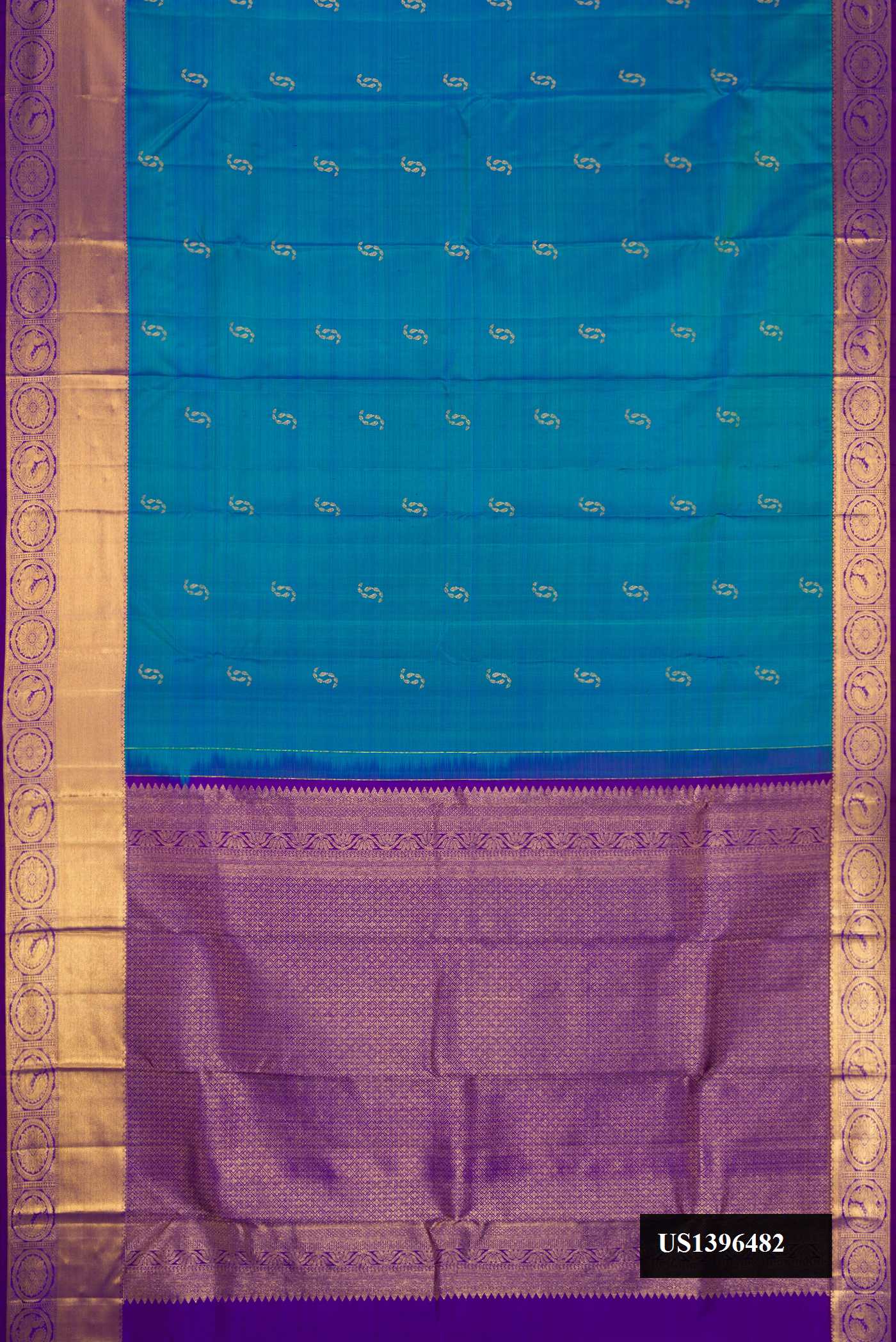 Peacock Blue Dual Tone Kanchipuram Silk Saree with Zari Butta on the body and Zari Border.  displayed on a mannequin