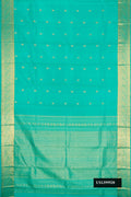 Sea Green Dual Tone Kanchipuram Silk Saree with Zari Butta on the body and Zari Border.  displayed on a mannequin