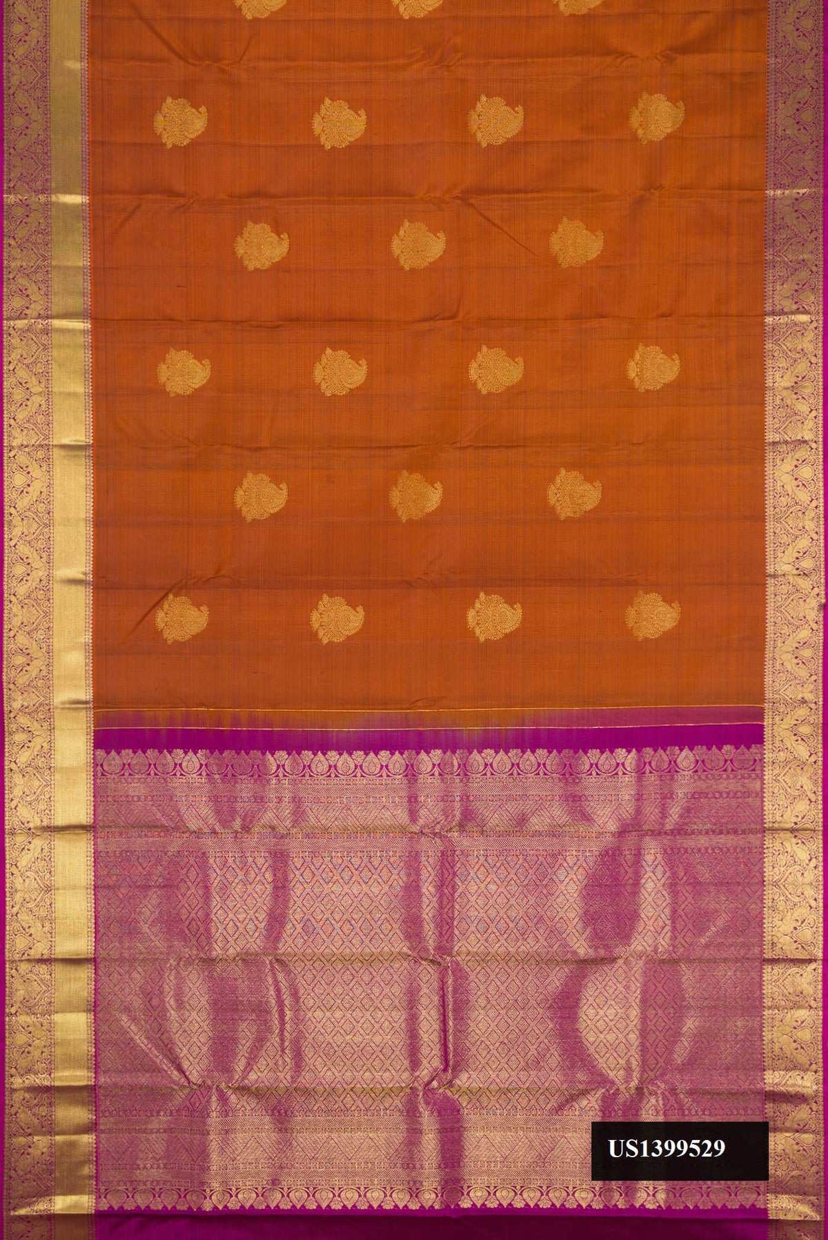 Brick Orange Dual Tone Kanchipuram Silk Saree with Zari Butta on the body and Zari Border.  displayed on a mannequin