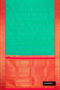 Green Dual Tone Kanchipuram Silk Saree with Zari Butta on the body and Zari Border.  displayed on a mannequin