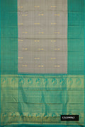 Grey Dual Tone Kanchipuram Silk Saree with Zari Butta on the body and Zari Border.  displayed on a mannequin