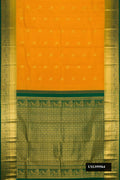Mustard Dual Tone Kanchipuram Silk Saree with Zari Butta on the body and Zari Border.  displayed on a mannequin