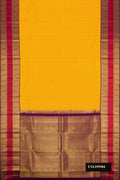 Mustard Dual Tone Kanchipuram Silk Saree with Zari Butta on the body and Zari Border.  displayed on a mannequin