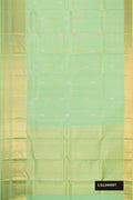 Pista Green Dual Tone Kanchipuram Silk Saree with Stripes on the body and Zari Border.  displayed on a mannequin