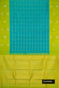 Peacock Blue Dual Tone Kanchipuram Silk Saree with Checked design on the body and Fancy Border.  displayed on a mannequin