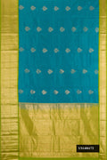 Green Dual Tone Kanchipuram Silk Saree with Zari Butta on the body and Zari Border.  displayed on a mannequin