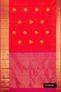 Brick Orange Dual Tone Kanchipuram Silk Saree with Zari Butta on the body and Zari Border.  displayed on a mannequin
