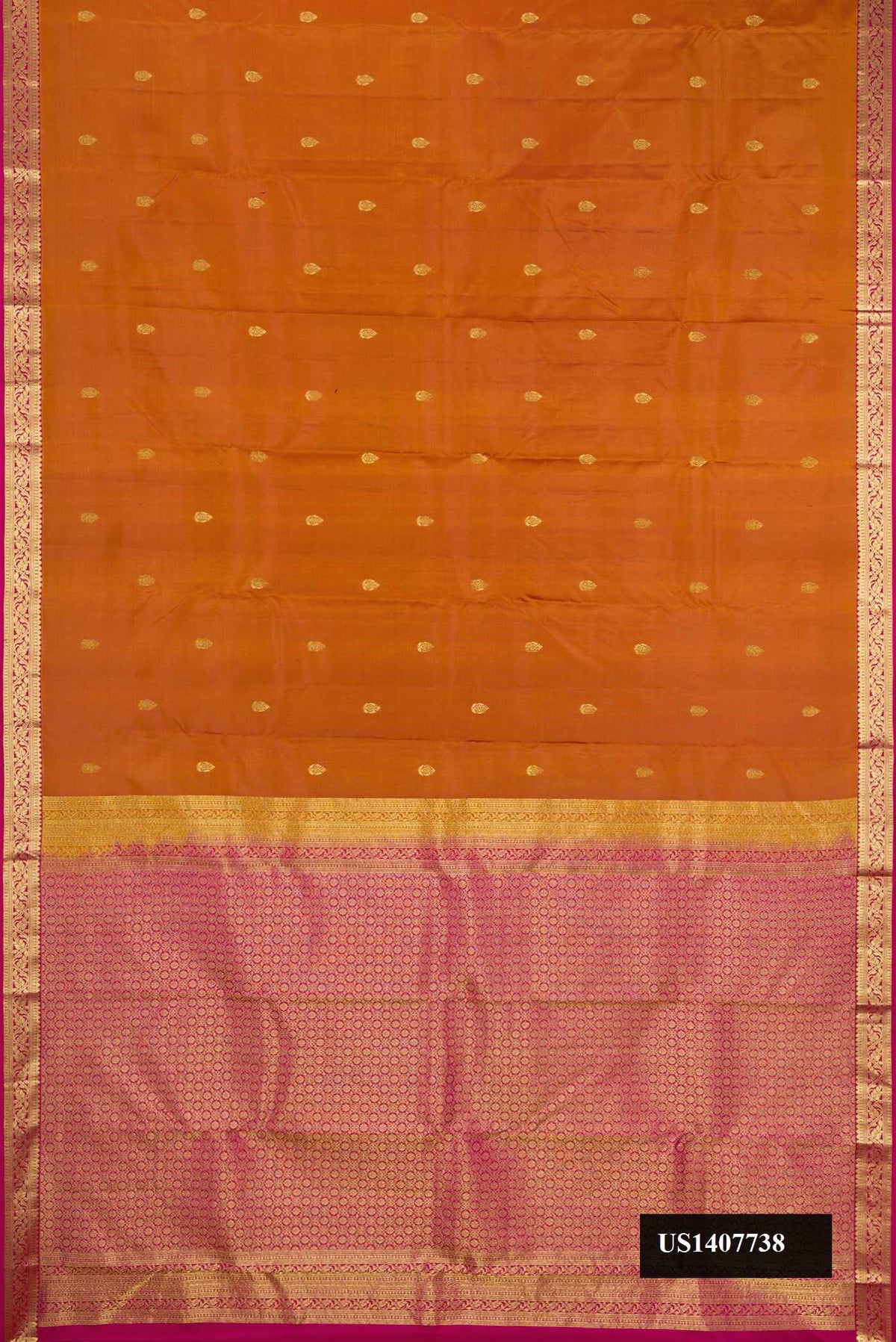 Rust Dual Tone Kanchipuram Silk Saree with Zari Butta on the body and Zari Border.  displayed on a mannequin