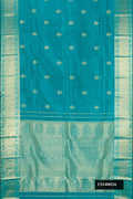 Teal Dual Tone Kanchipuram Silk Saree with Zari Butta on the body and Zari Border.  displayed on a mannequin