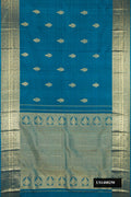 Teal Dual Tone Kanchipuram Silk Saree with Zari Butta on the body and Zari Border.  displayed on a mannequin
