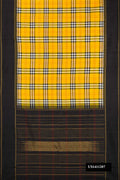 Black and Yellow Dual Tone Kanchipuram Silk Saree with Checked design on the body and Zari Border.  displayed on a mannequin