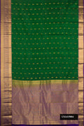Green Dual Tone Kanchipuram Silk Saree with Zari Butta on the body and Zari Border.  displayed on a mannequin