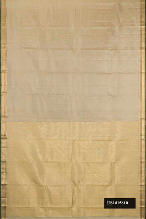 Beige Dual Tone Kanchipuram Silk Saree with Zari Butta on the body and Zari Border.  displayed on a mannequin