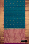 Peacock Blue Dual Tone Kanchipuram Silk Saree with Zari Butta on the body and Zari Border.  displayed on a mannequin
